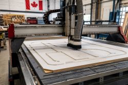 Small-format CNC router cutting a sign panel in a Canadian small shop